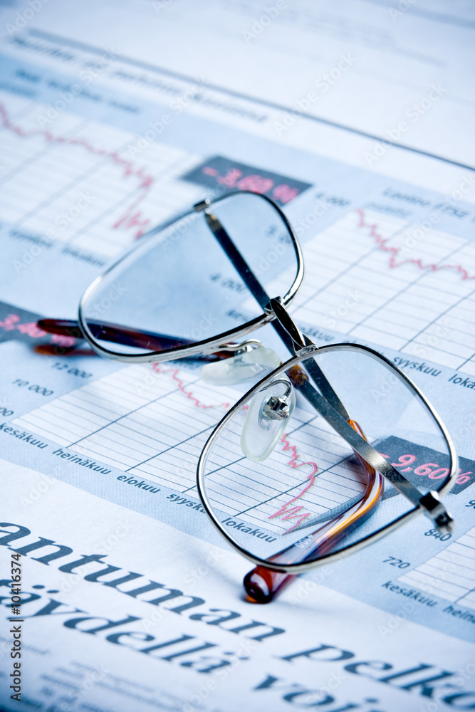 glasses on financial diagram. business concept glasses on financial diagram. business concept