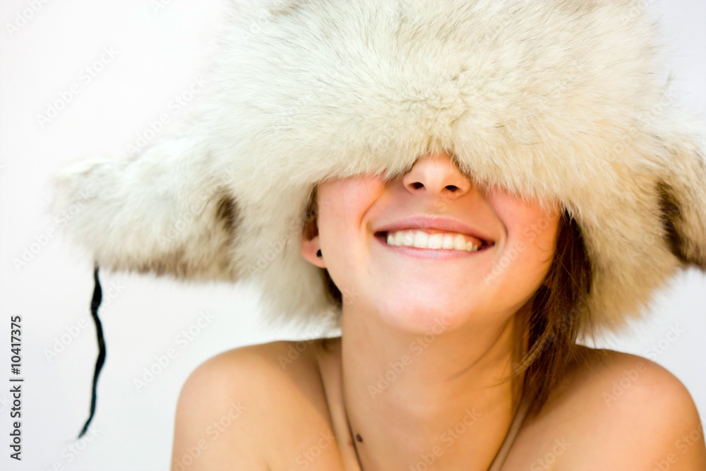 portrait of young beautiful woman in cap with ear flaps portrait of young beautiful woman in cap with ear flaps