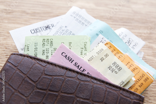 Bilde på lerret Leather Wallet Containing Receipts On Wooden Counter