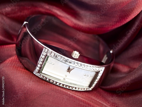 lady clock at wine-colored textile