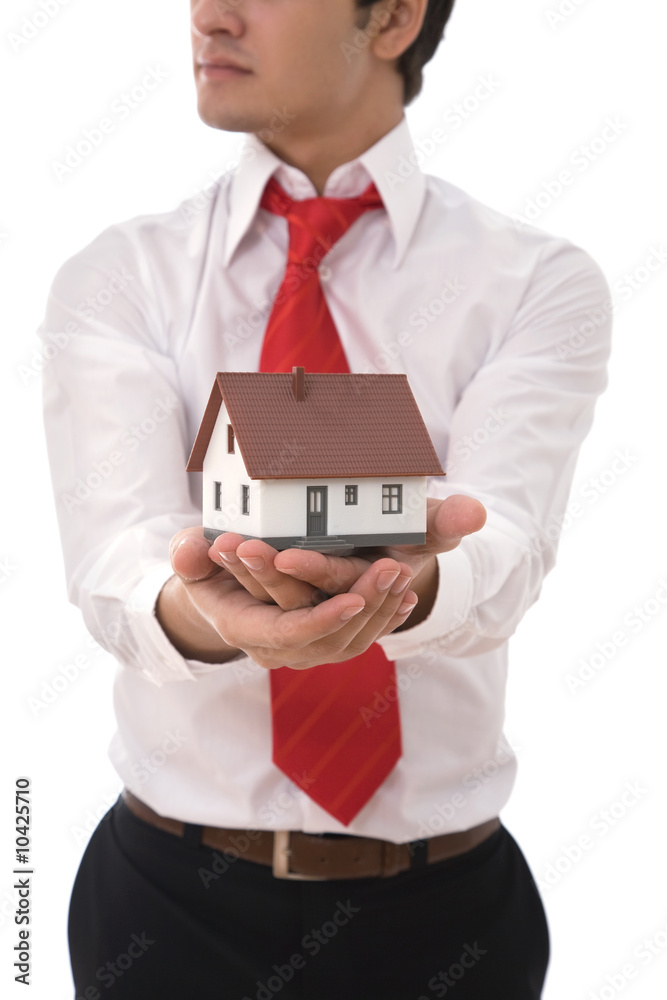 businessman with a mini house for real estate concept businessman with a mini house for real estate concept