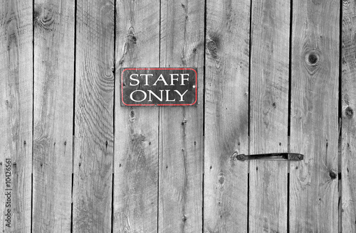 staff only sign on an old wooden door