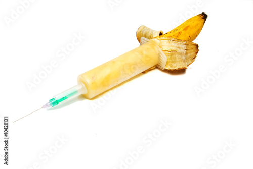 A banana loaded in to a medical syringe. photo