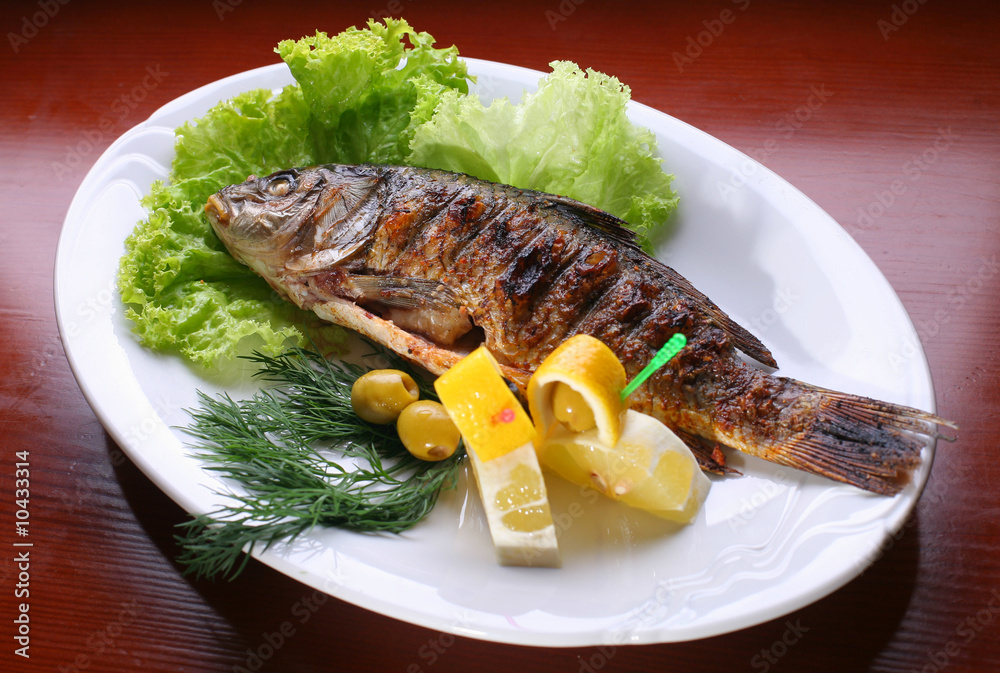 Dish with fish by a carp