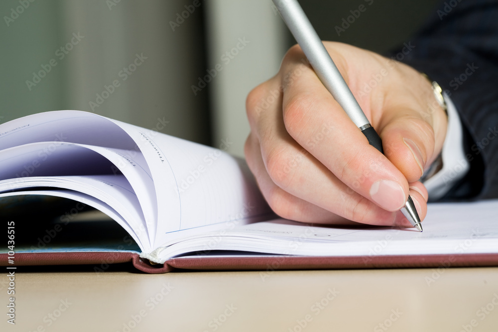 Close up of a hand of the writing businessman Close up of a hand of the writing businessman