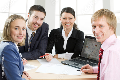 Four businesspeople smiling