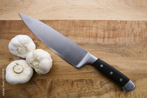 Thee Pieces of Garlic, Knife and Cutting Board