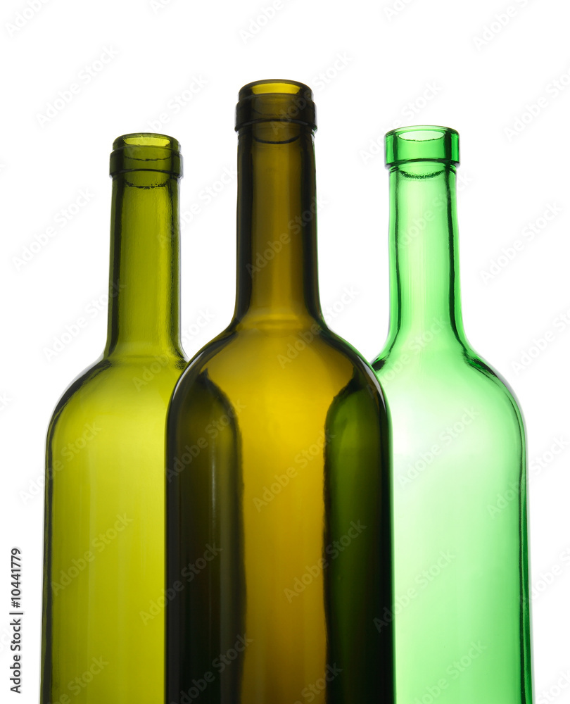 Three empty green wine bottles on white background.