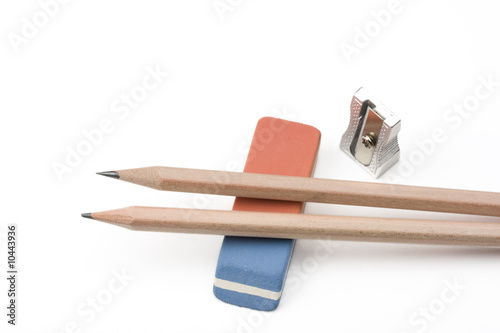 a pen, a sharpener and an eraser