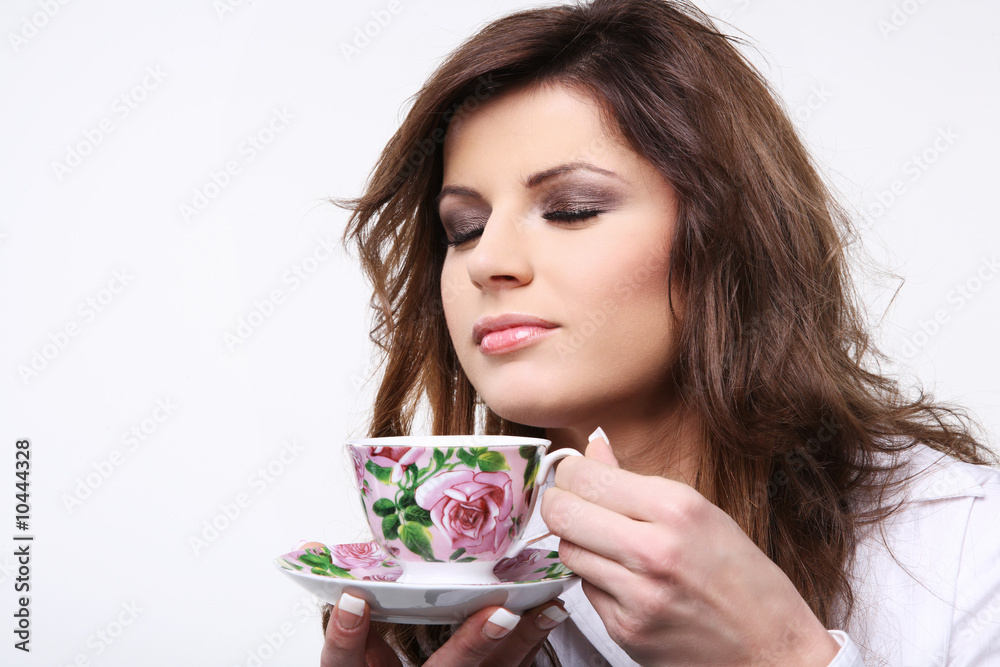 Beautiful young woman enjoying hot cup of tea... Beautiful young woman enjoying hot cup of tea...