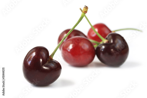 Fresh red cherries, isolated on white with soft shadow.