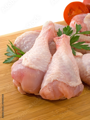 Fresh raw chicken legs on wooden board