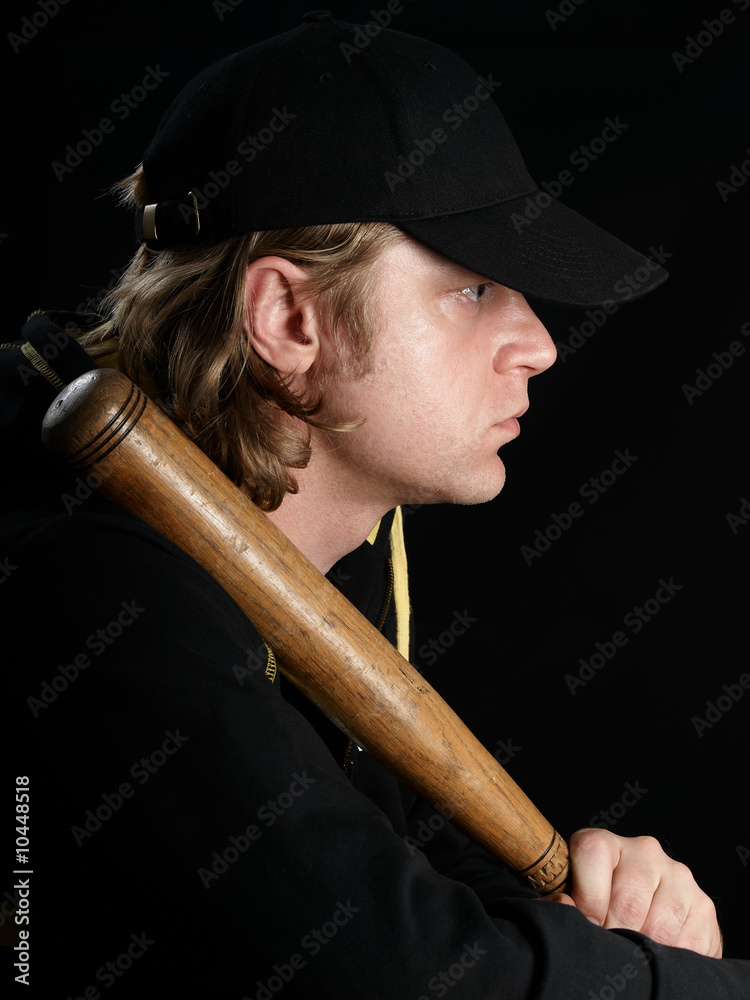 Man's profile portrait with baseball bat in black. Man's profile portrait with baseball bat in black.