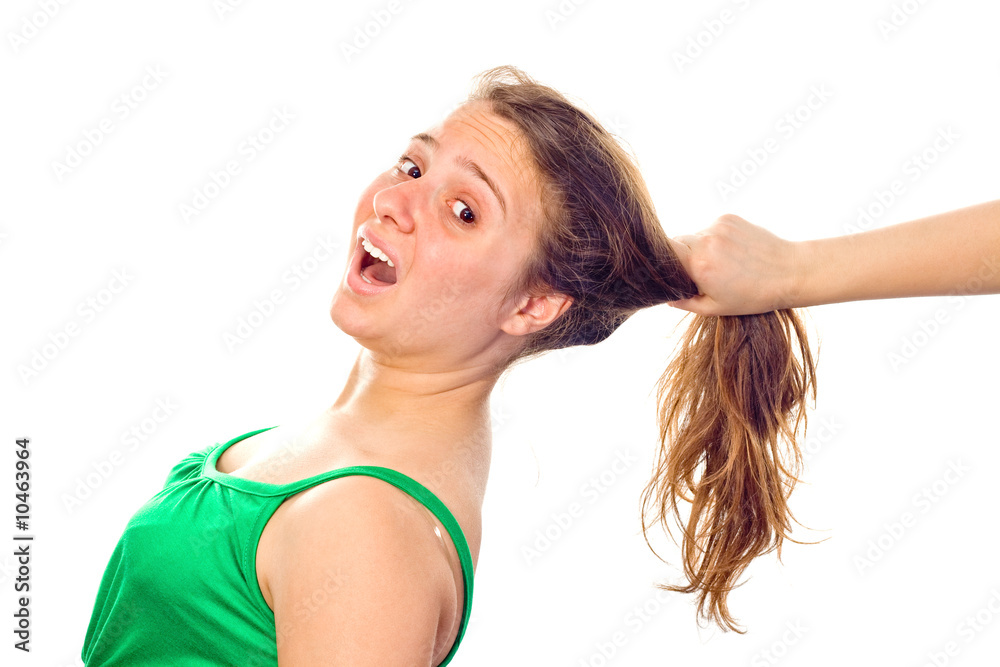 A hand grabbing the girl's long hair. White background. A hand grabbing the girl's long hair. White background.