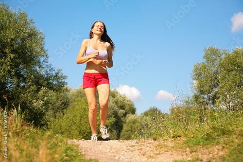 Young girl runs in forest