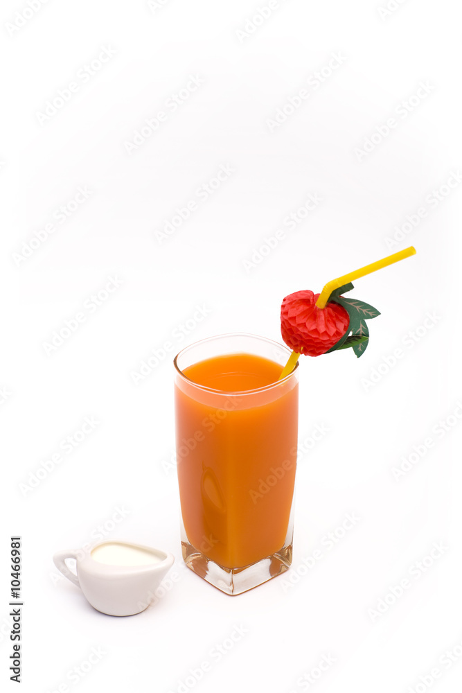 Glass of carrot juice and fresh cream on a white background