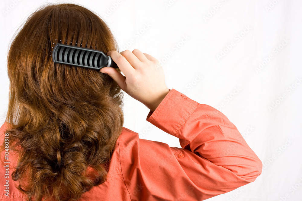 Obraz premium Woman brushing her hair isolated on white