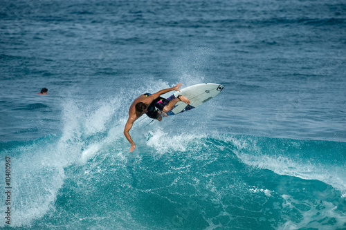 surfer doing a frontside ariel © NorthShoreSurfPhotos