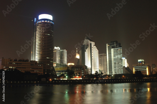 Ningbo - night cityscape with river and skyscrapers photo