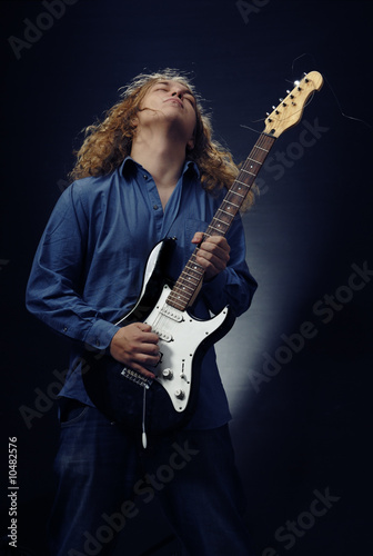 Man with electric guitar playing rock music