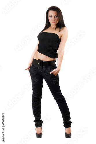 The sexy young woman in a black jeans. Isolated on white
