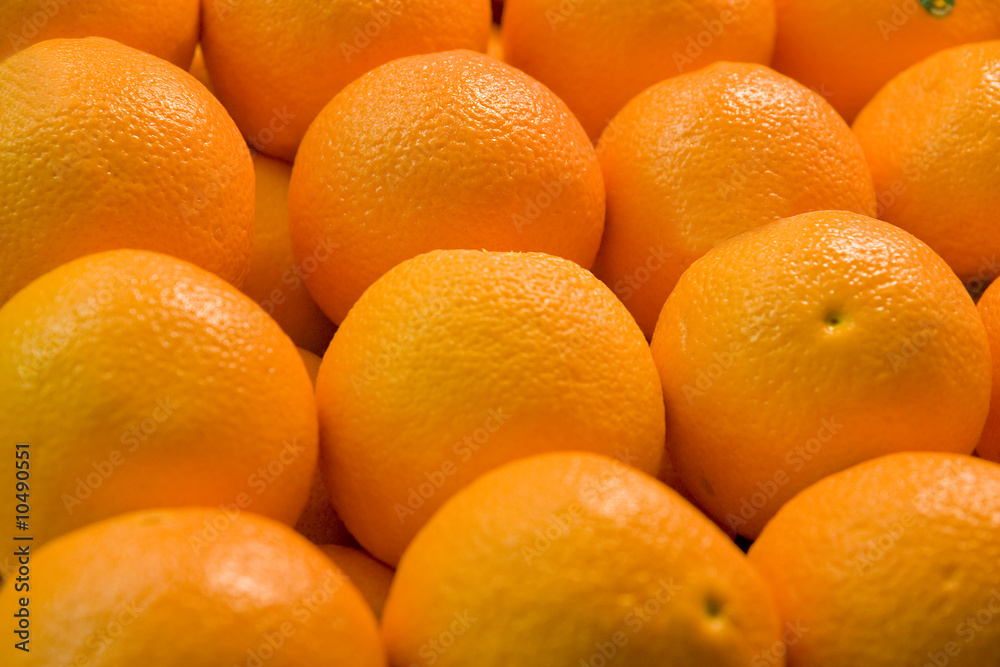 A display of fresh juicy naval oranges in a fruit market A display of fresh juicy naval oranges in a fruit market