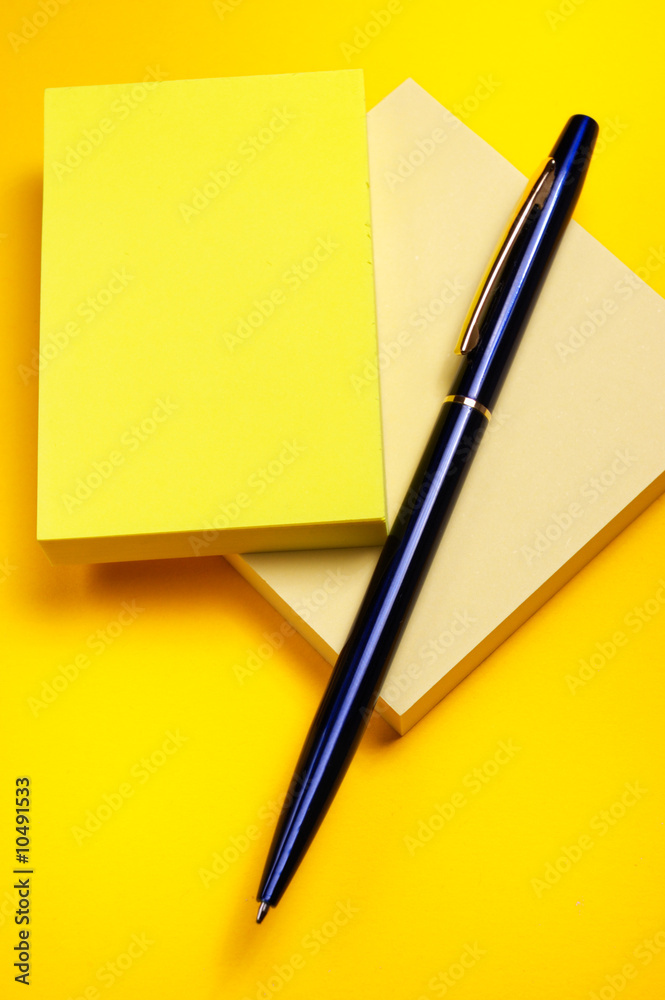Yellow sticky note and pen Yellow sticky note and pen
