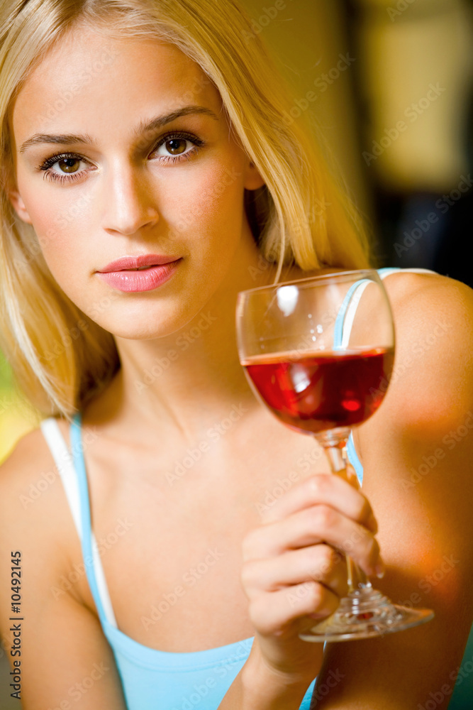 Portrait of young beautiful blond woman with redwine glass Portrait of young beautiful blond woman with redwine glass