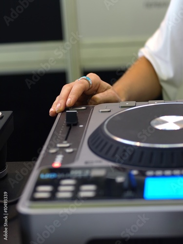 Close up of Lady's hand on DJ sound mixer