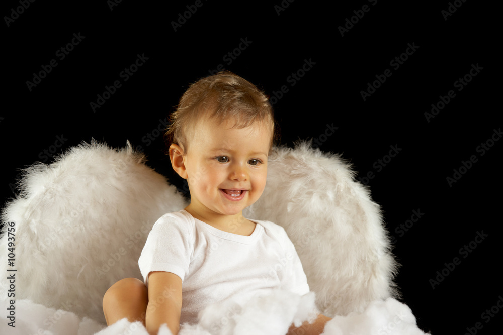 baby girl with angel wings sitting in soft white batting baby girl with angel wings sitting in soft white batting