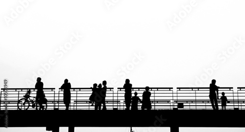 Outline silhouette of pedestrians on a bridge..