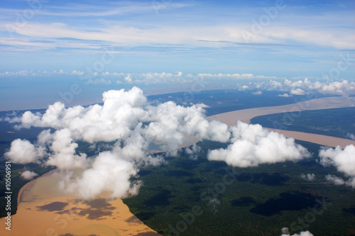 Aerial view of cloud over river and land.
