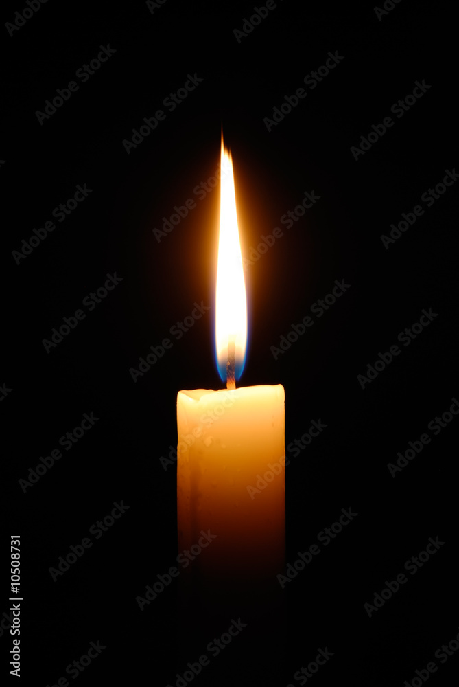 Closeup of burning candle isolated on black background Closeup of burning candle isolated on black background