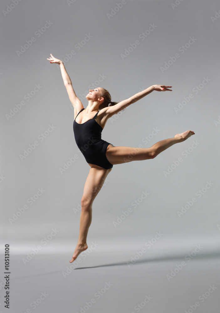 young and beautiful ballet dancer posing on gery