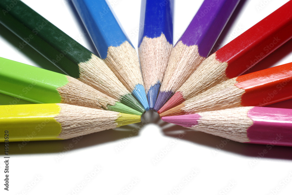 Half-circle of colour pencils isolated on white background.