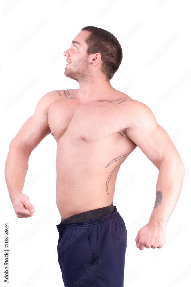 young bodybuilder posing in front of white background
