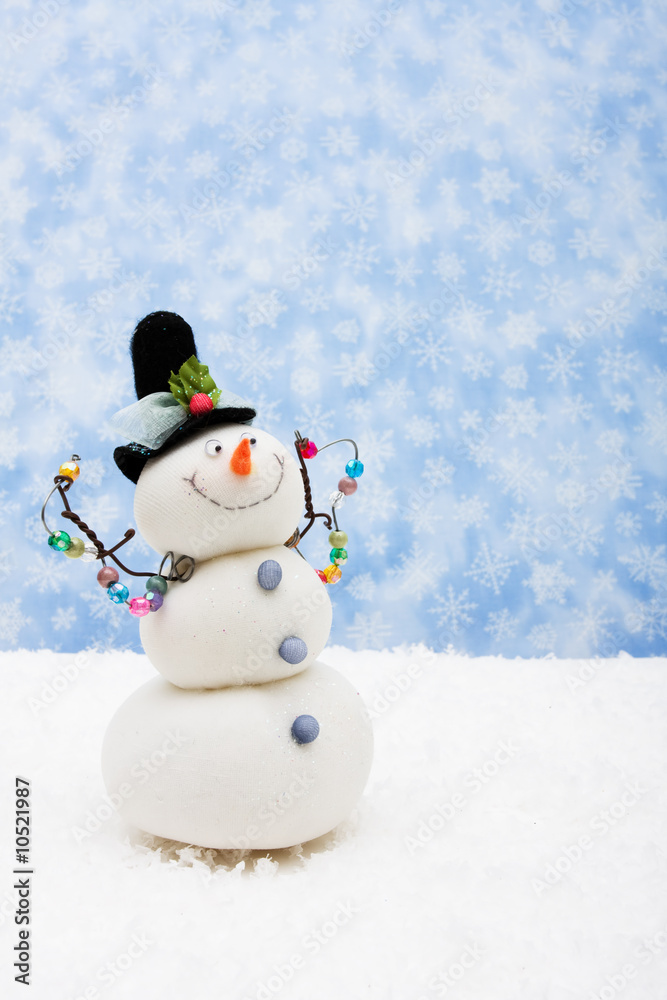 Fototapeta premium Snowman sitting on snow with snowflake background