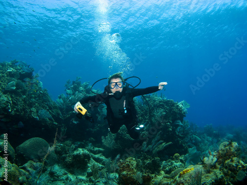 Smiling Scuba Diver descending on a Reef in Cayman Brac