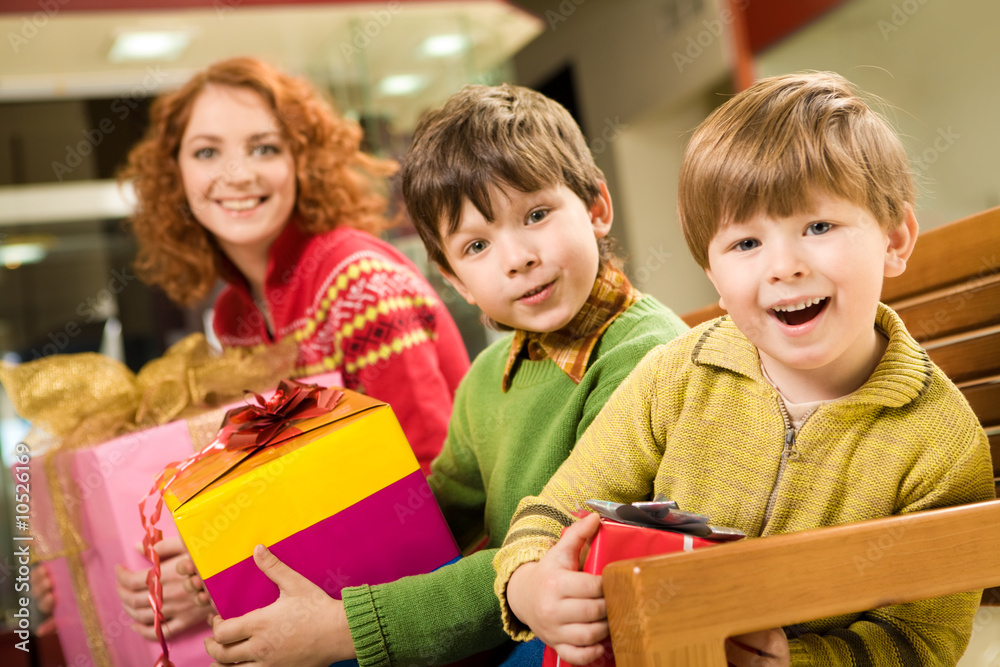 Portrait of astonished brothers with nice gifts Portrait of astonished brothers with nice gifts
