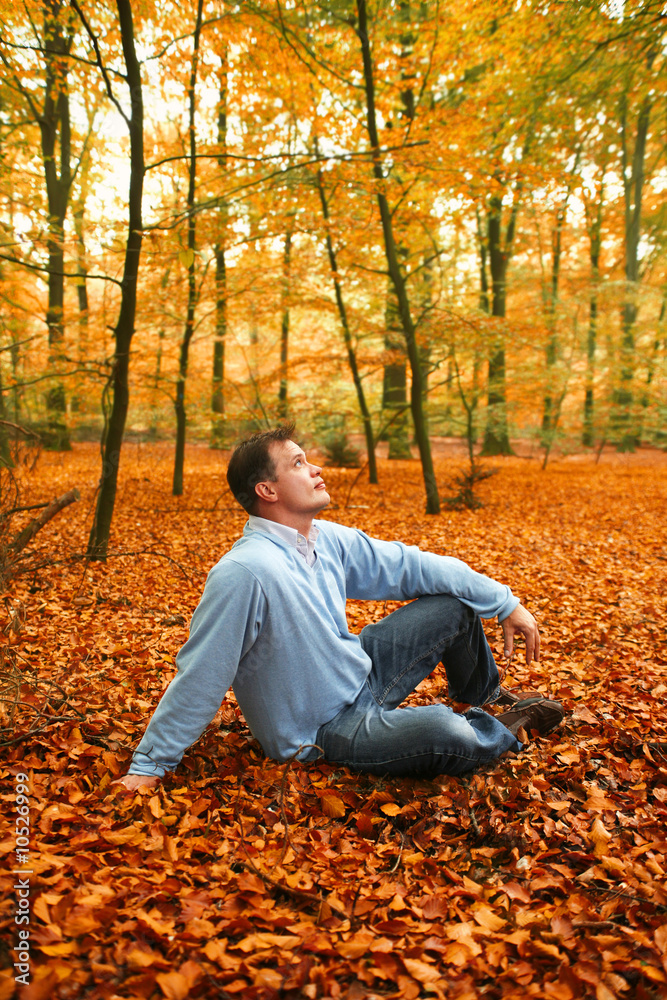 man in autumn park on cover from leafs man in autumn park on cover from leafs