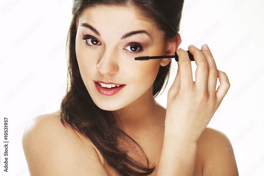 Pretty woman applying make up