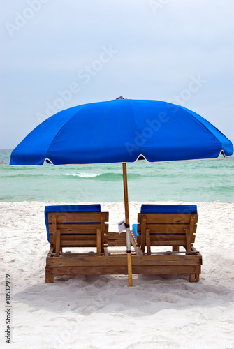 wooden chairs on a florida beach © Laura Ballard
