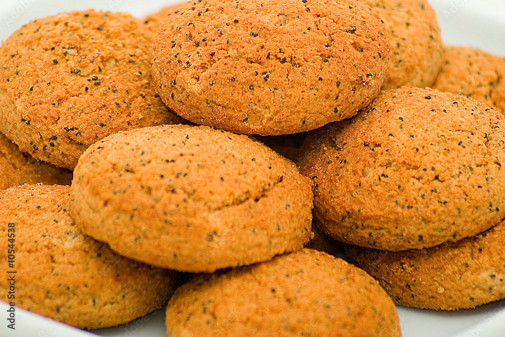 Oats cookies with a poppy on a plate. Focus on the top biscuits Oats cookies with a poppy on a plate. Focus on the top biscuits