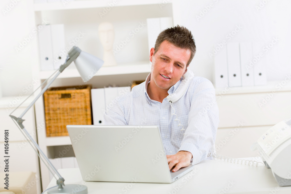 Business man working on laptop computer at home. Business man working on laptop computer at home.