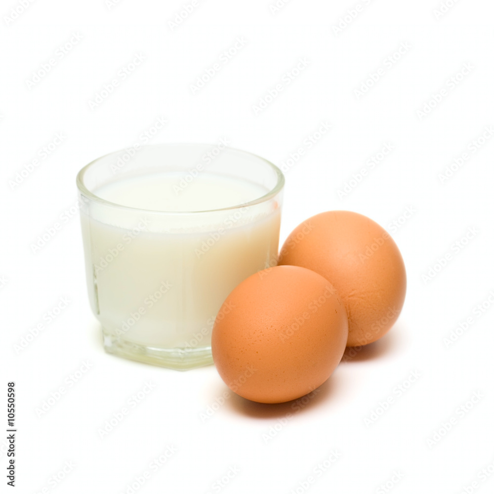Glass with milk and eggs isolated on white Glass with milk and eggs isolated on white