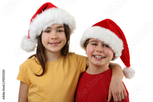 Kids wearing Santa Claus hats isolated on white background