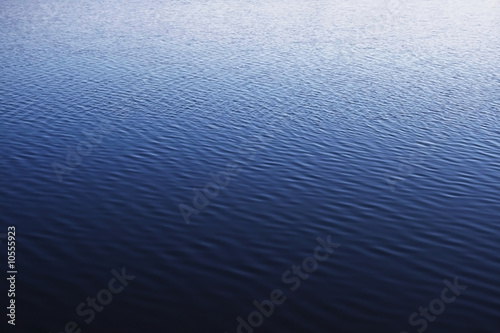 blue water surface of quiet lake with wavelets