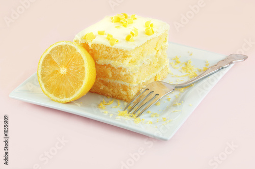 Lemon cake with a fork on a white plate.