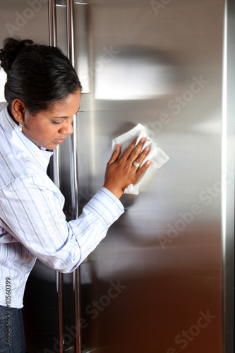 Woman cleaning her stainles...