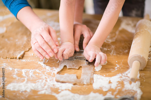 Young mother and son in kitchen making cookies.